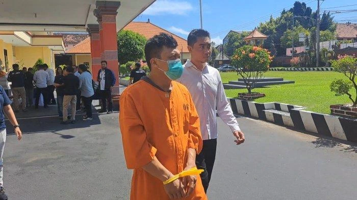 Tersangka kasus narkotika berinisial AB saat digiring petugas Satres Narkoba Polres Buleleng usai diamankan di sebuah rumah kontrakan di kawasan Lovina, Sabtu (26/4/2025).