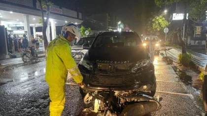 Petugas kepolisian memeriksa kondisi sepeda motor yang ringsek setelah terlibat tabrakan dengan mobil Pajero di simpang empat Dauhwaru, Jembrana, Rabu (30/7/2025) malam. (Foto: Istimewa)